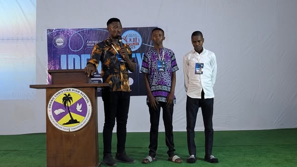 Young men standing with a speaker during the 2025 Forum